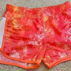bright pink, orange, and yellow athletic shorts